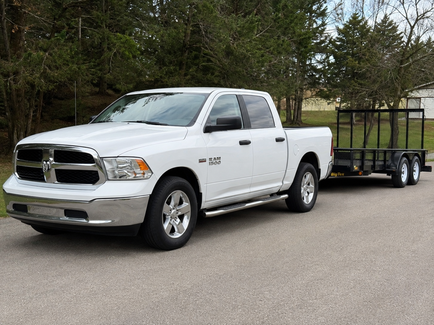 Migos Junk Removal white Ram 1500 pickup truck with Big Tex utility trailer serving the Rio Grande Valley